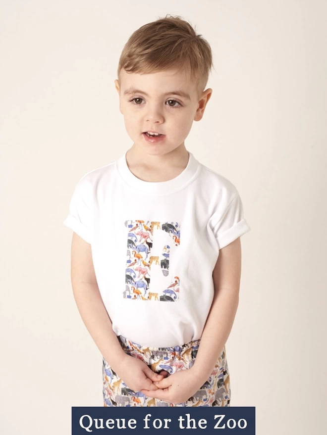 Childrens T-shirt in white with initial on the front in Queue for the Zoo  Liberty print fabric