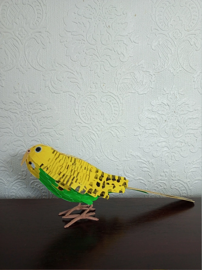side view of a yellow budgie sculpture