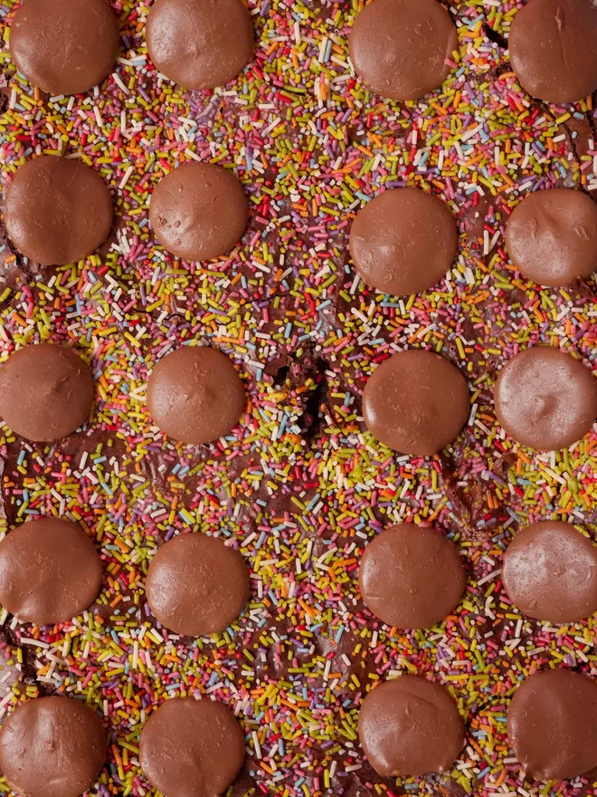 Birds eye view, close up of Funfetti brownies with sprinkles and milk chocolate buttons