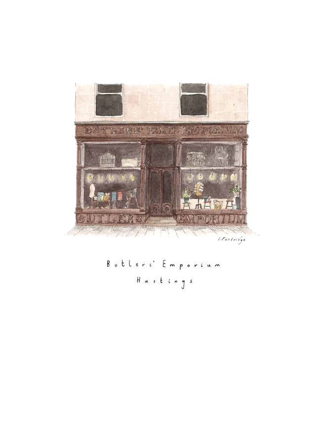 Watercolour illustration of Butler’s Emporium shop in Hastings, a brown shopfront with beautiful big windows full of treasures, the shop sells homewares and gifts carefully curated from small independent and local businesses. The painting is on a white piece of paper with the name written below.