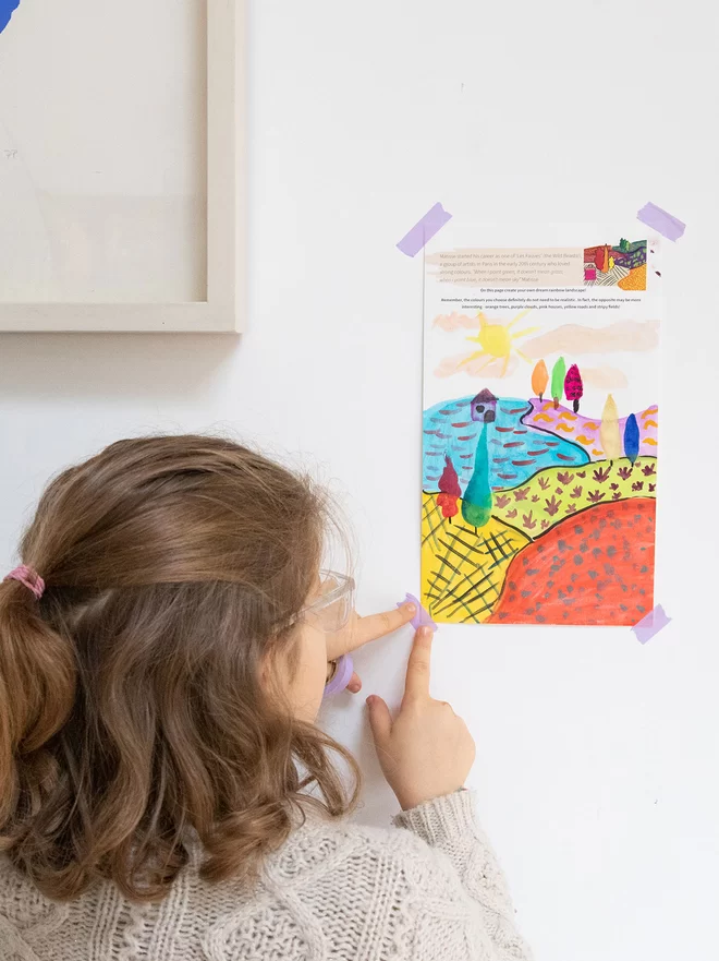 Funny Feelings Sketchbook for Children putting artwork on the wall, the sketchbook helps you create mini masterpieces