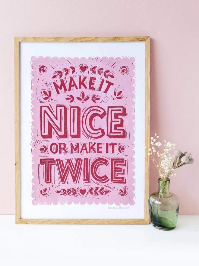 pink make it nice or make it twice print with small vase of flowers