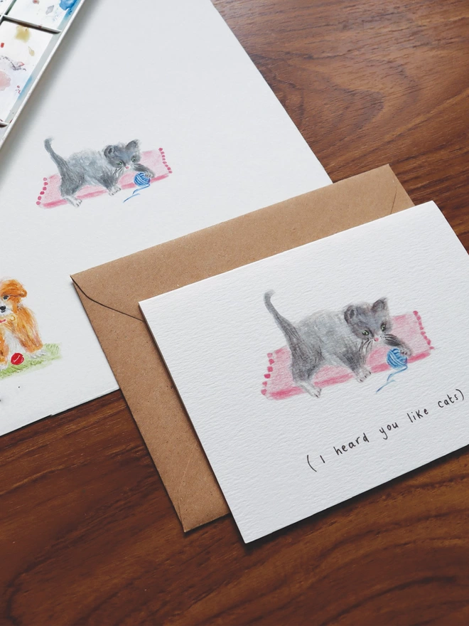 Cat Greeting Card featuring a grey kitten playing with a blue ball of wool.  