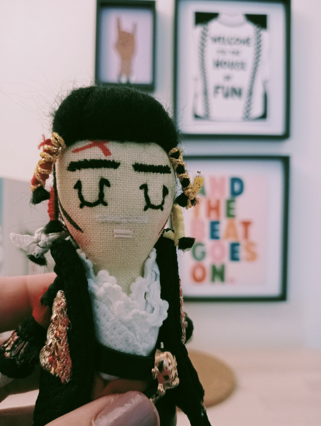 1980s Adam Ant mini decorative icon doll in front of a mini gallery of music themed prints 