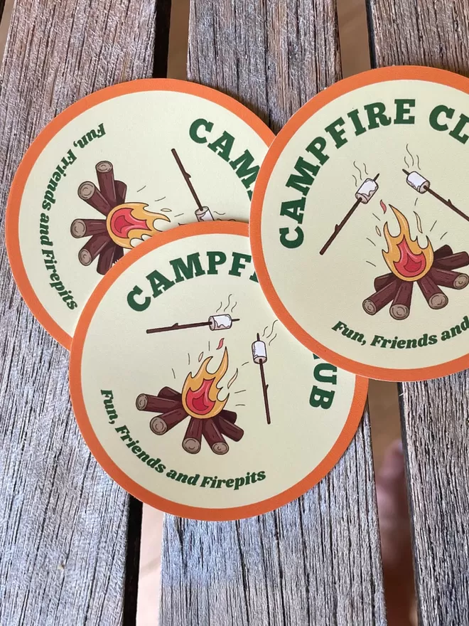 Campfire Club Vinyl Stickers on a wooden table.