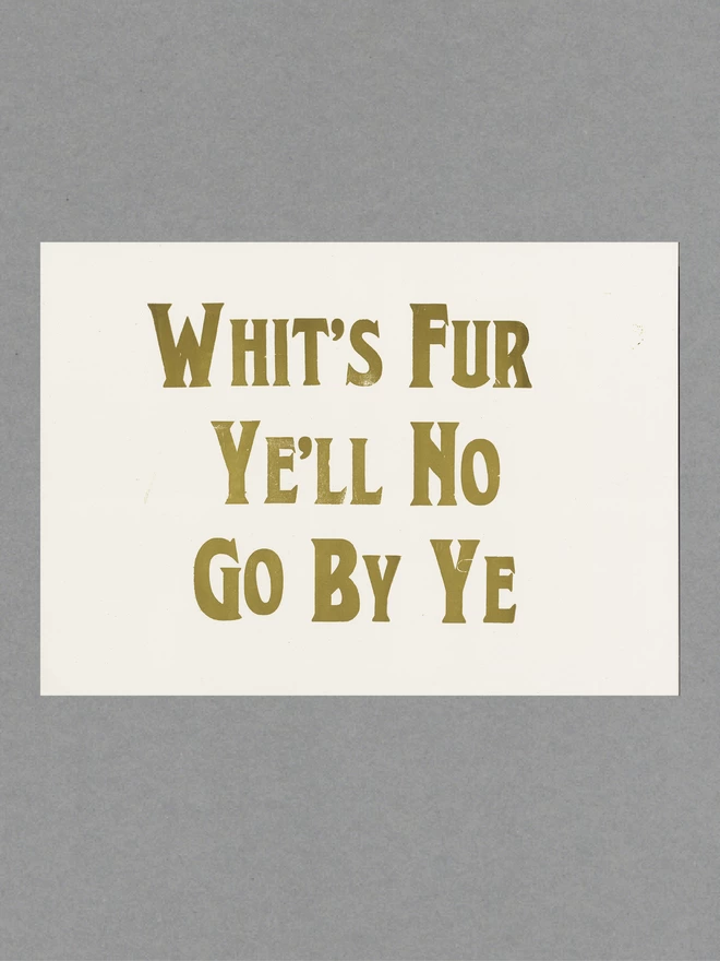 Poster with gold text reading 'Whit's Fur Ye'll No Go Bo Ye' on white paper