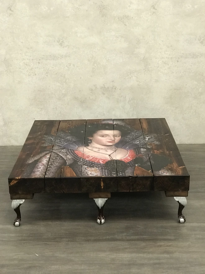 bespoke coffee table with 8 legs and image of a queen on the surface