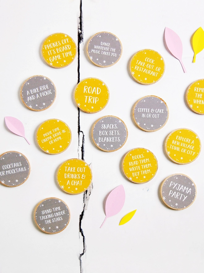 Fifteen wooden tokens with yellow and grey labels, each with a friendship 