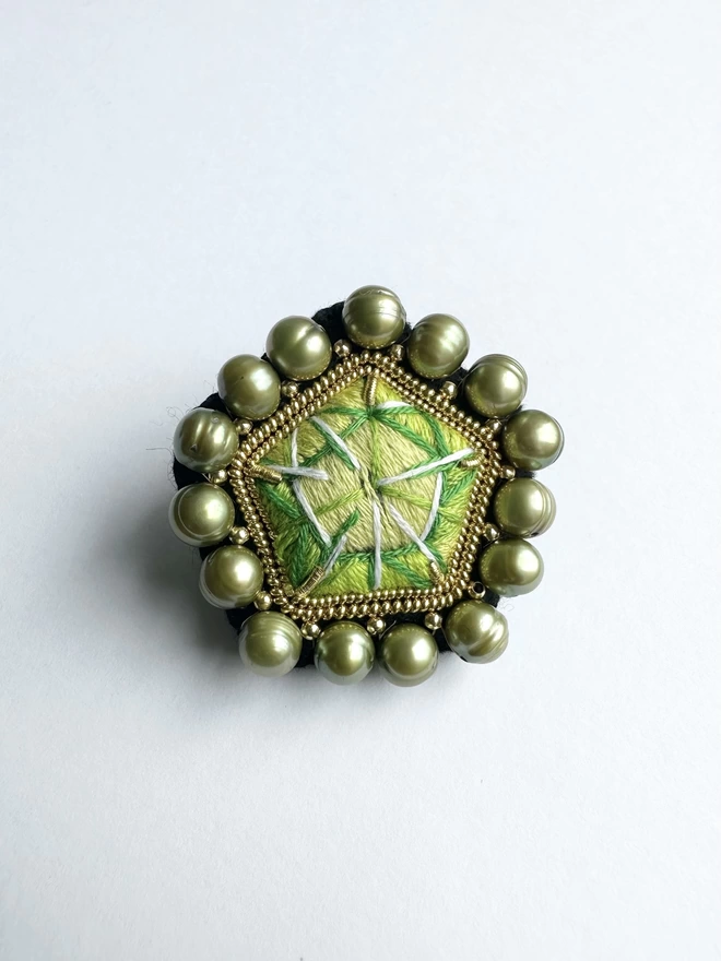 Green gemstone brooch