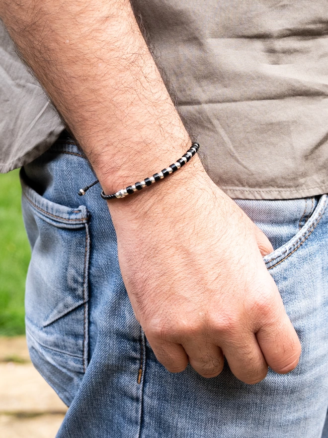 men wearing a silver and onyx bracelet