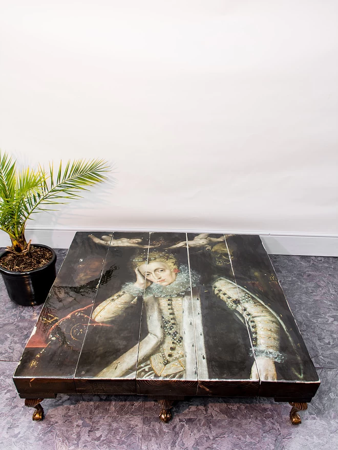 dark image of queen on the surface of a grand coffee table