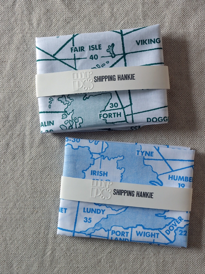 two folded Mr.PS Shipping Hankies, one in sea green and one in sky blue