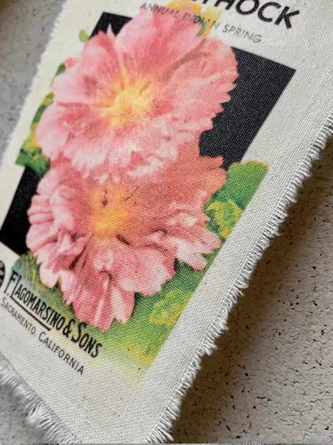 A vintage hollyhock seed packet printed onto fabric