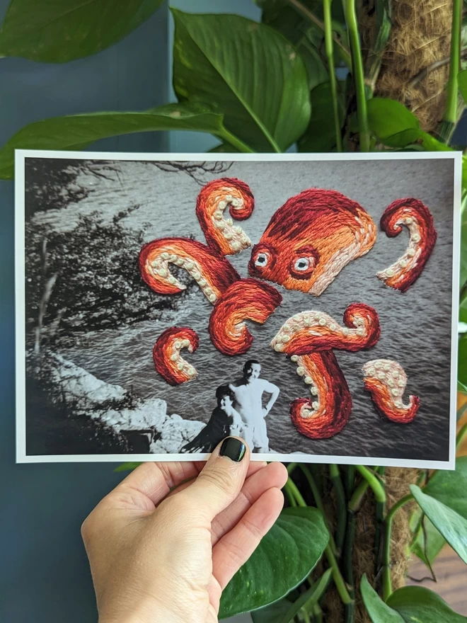 B&W print of photo of couple with embroidered octopus behind them, held against blue background