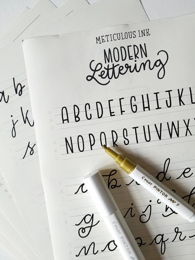 Meticulous Ink Modern Lettering Kit - Close up of guidesheets with open pen