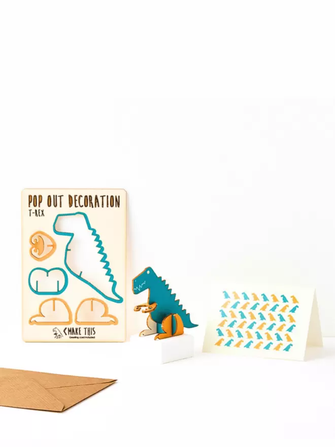 Dinosaur decoration and dinosaur pattern greeting card and brown kraft envelope on a white background