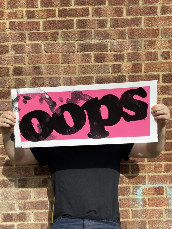 "OOPS" Foot Smeared Screenprint with each print individually smudged by the artists foot creating a one of a kind artwork with pink background 