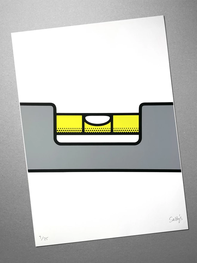 A screenprint of a spirit level sits on a grey background. The image depicts a close up of the bubble, showing level status - however the picture is printed at an angel - so it would suggest it will need to be hung so.