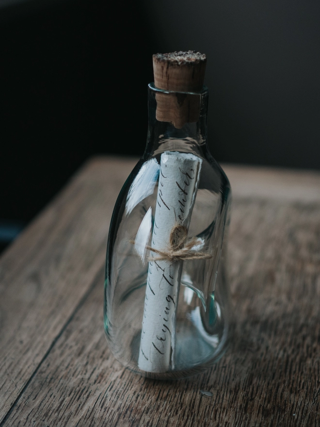 Message in a glass bottle with cork, side view