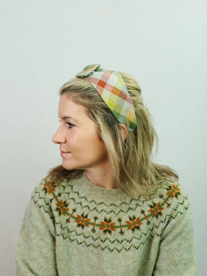 model in green check hairband
