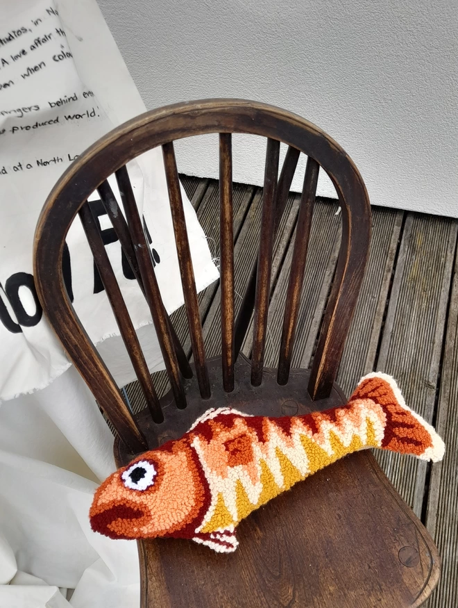Rustic fish cushon on vintage wood chair