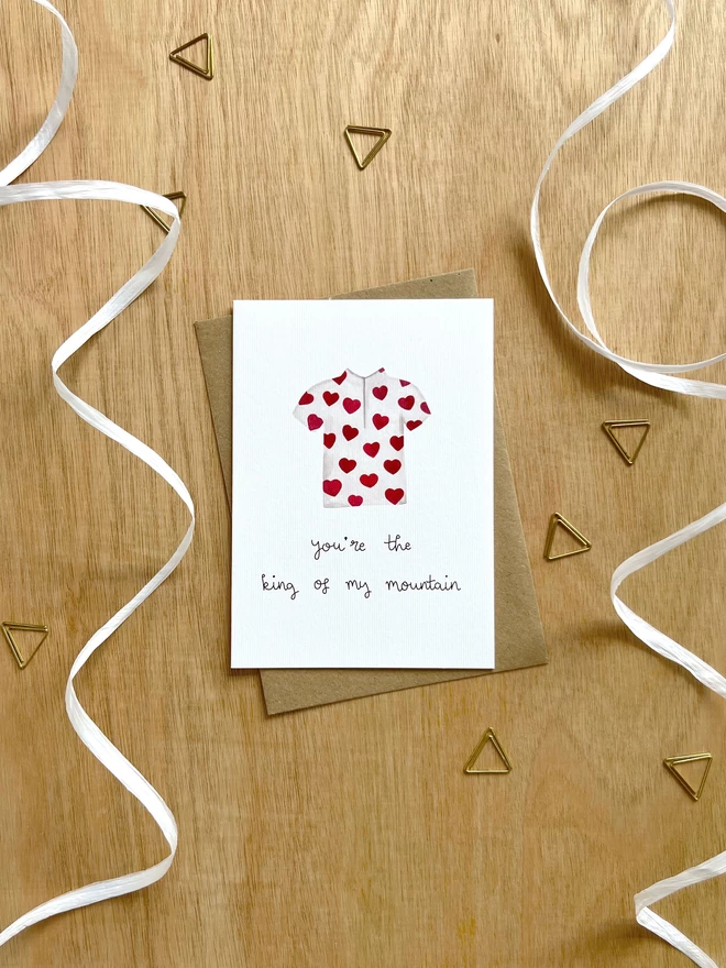 a greetings card with a polka dot king of the mountains cycling jersey where the spots are hearts and the text “you’re the king of my mountain”