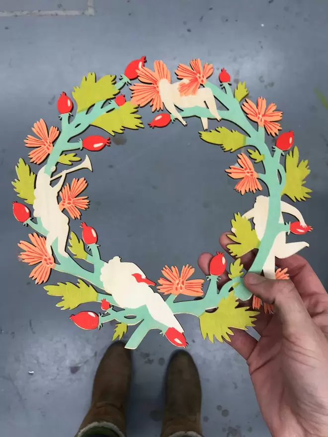 Fiona holds a wreath. 4 bright layers have been screenprinted, it just needs the final layer 