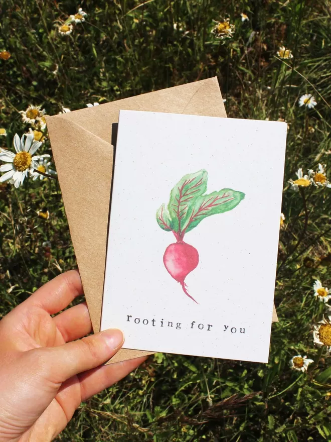 'Rooting For You' Card being held on daisy field