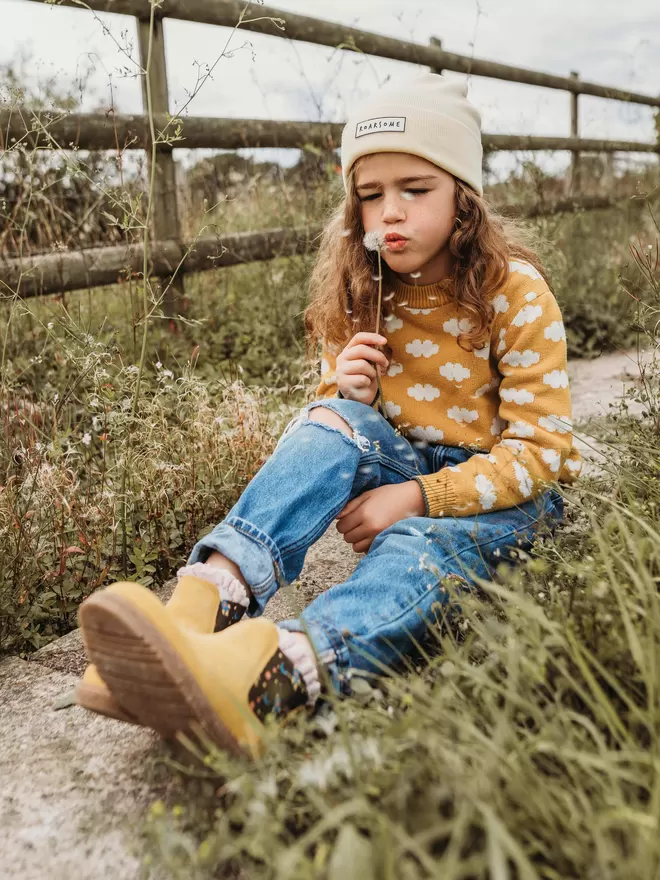 Child Wearing Mustard/ yellow coloured suede chelea boots with a space ship print