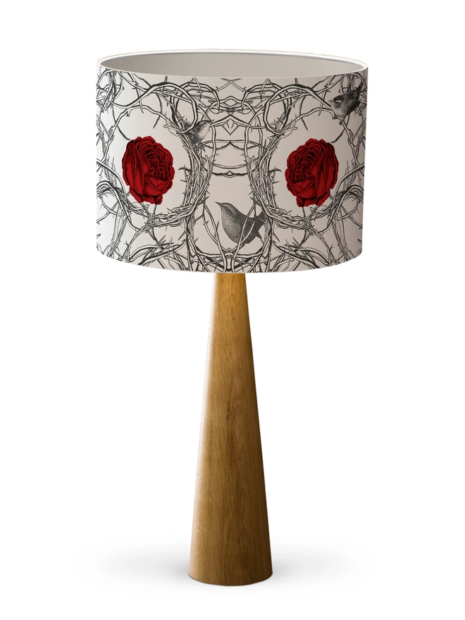 Drum Lampshade featuring red roses in branches with birds with a white inner on a wooden base on a white background