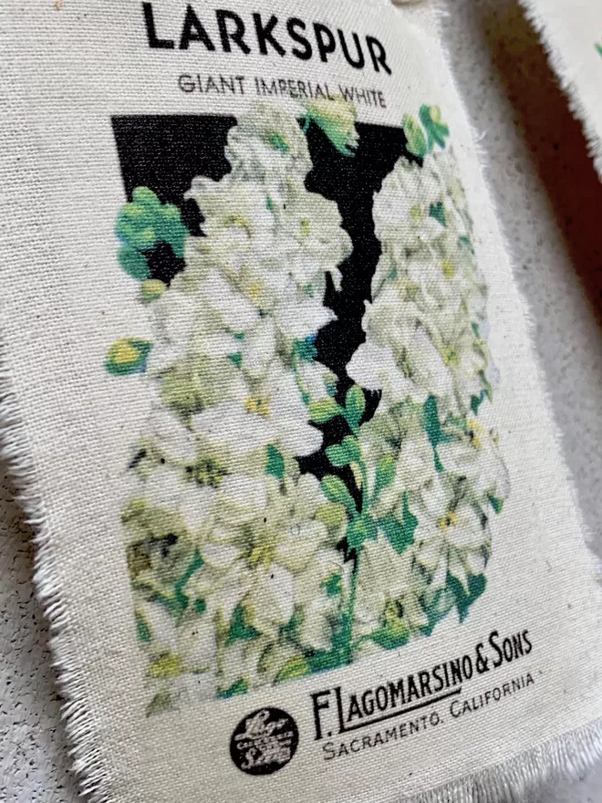 A vintage larkspur seed packet printed onto fabric