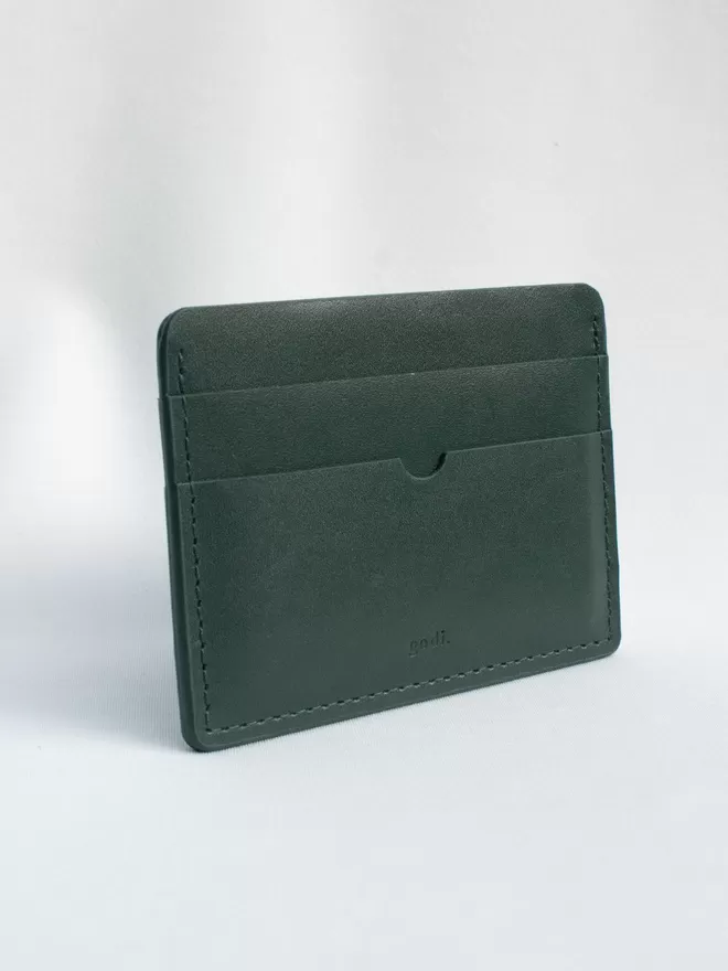 Dark Green Card Case at an angle on a white cloth