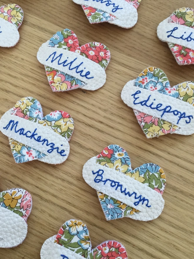 Hetty and Dave Liberty Floral heart hairslides with name stitched in blue across a white scroll