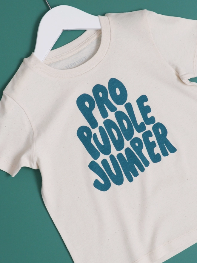 Pro Puddle Jumper slogan t-shirt laying on a green background