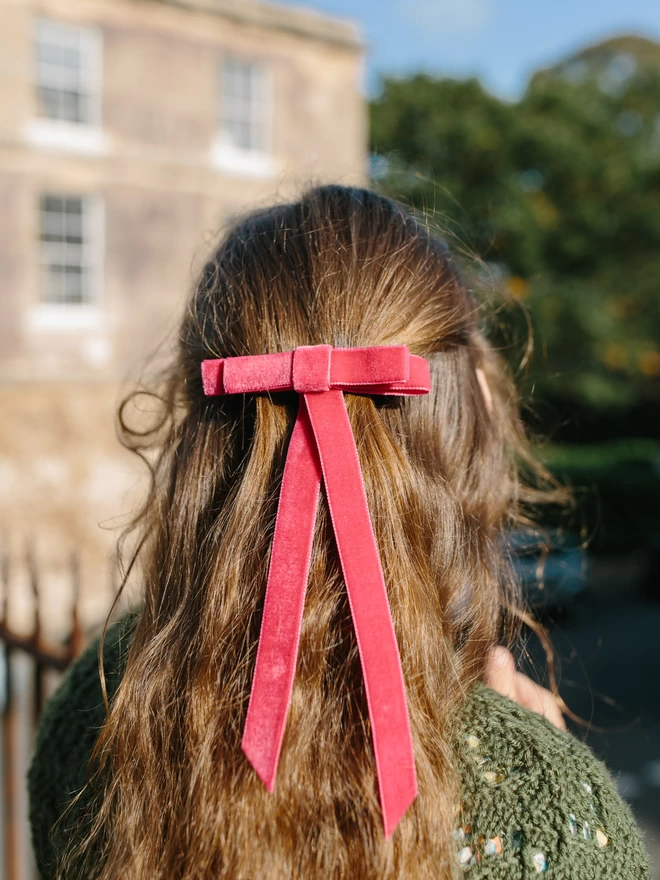 girl outside in her velvet hair bow
