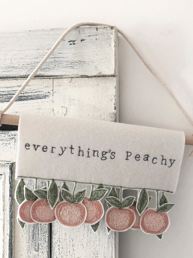 Everything's peachy banner hanging on a door.