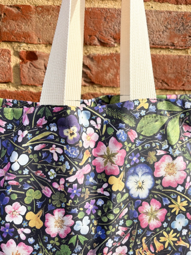Spring Floral Shopping Tote Against Brick Wall - Strong Webbed and Beautiful Delicate Floral Design