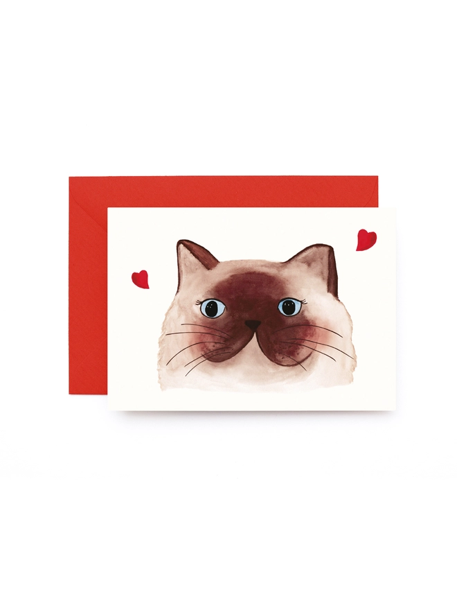 Greeting card with a picture of a swooning cat and love hearts