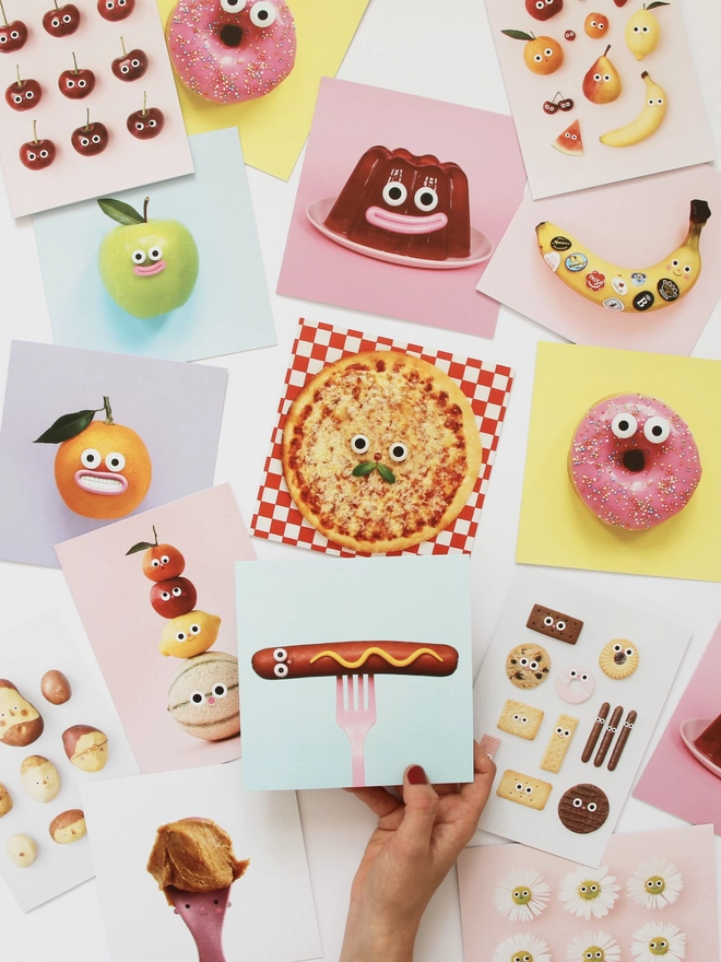 A collection of cards with food with faces. 