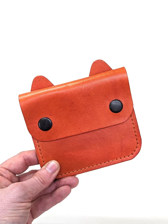 Front view of leather Cat Purse in orange.