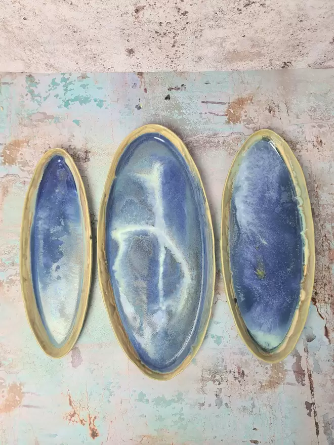 Serveware, Nesting set of three oval serving platters, serving dish, turquoise, green, Cobalt Blue glaze, stoneware clay, pottery, gifts, kitchen, dinnerware, serveware, photographed on a pink and blue background
