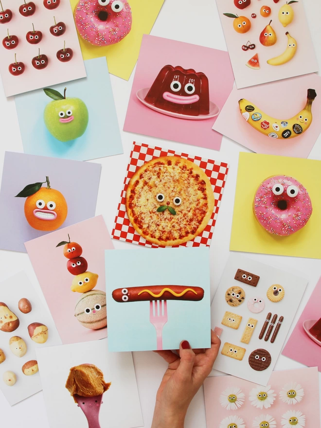 A selection of colourful cards all foods with faces