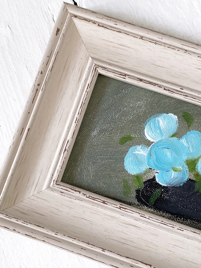 detail of framed blue flower painting