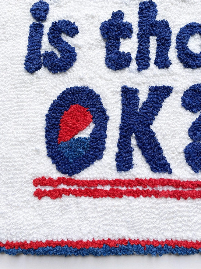 close up of "OK" with the blue, red and white Pepsi logo in the 'O' of "OK"