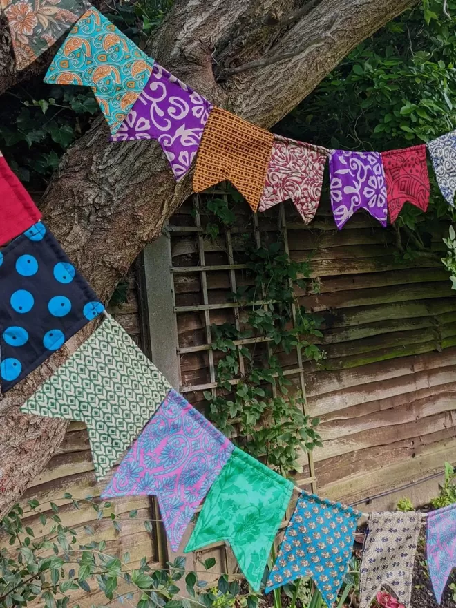 side view of bunting hanging outside in a variety of colours shown as decoration example with no personalisation