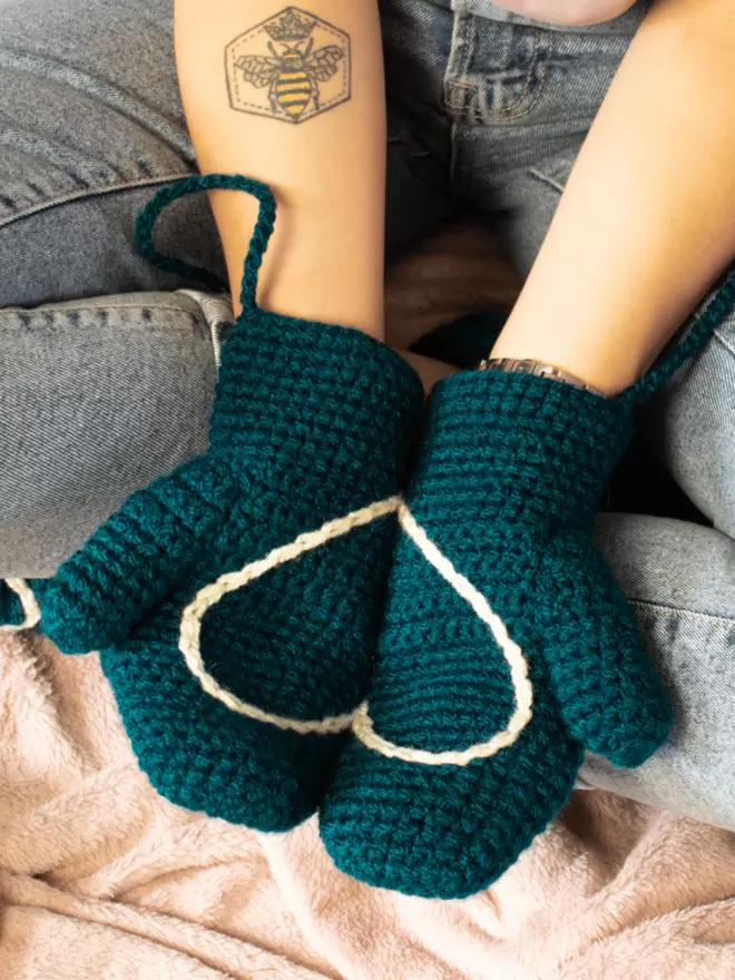 Teal mittens with a cream heart