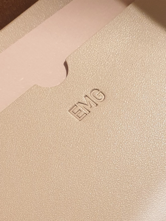 Image of personalsing with the initials EMG embossed on.