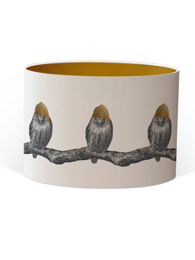 Drum Lampshade featuring little owls wearing a gold nightcap sitting on a branch with a Gold inner on a white background