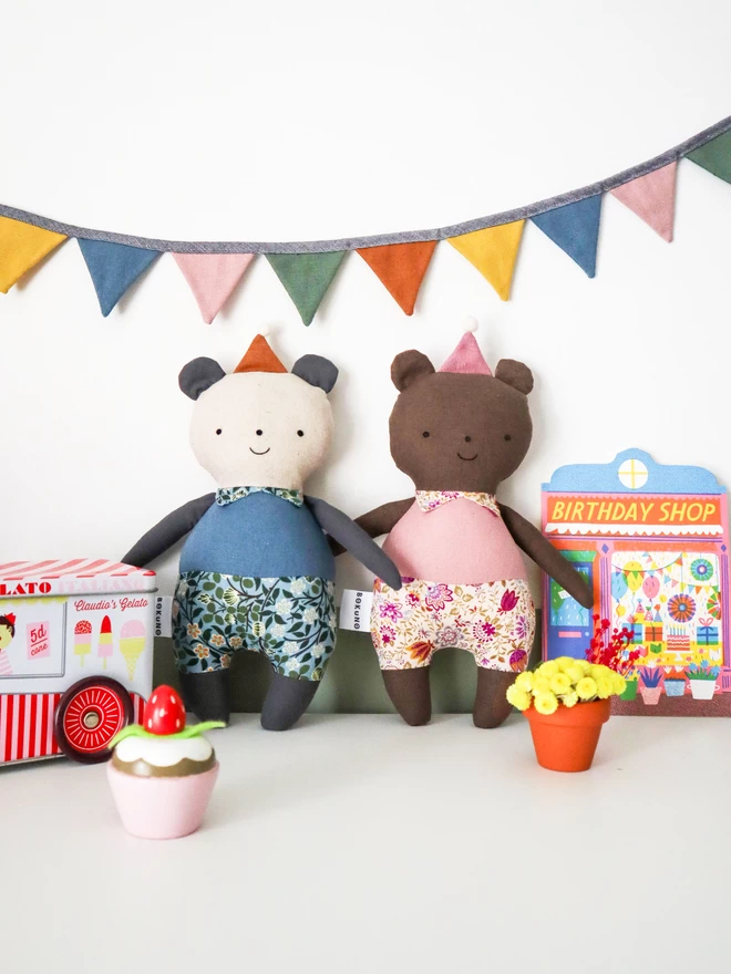 fabric panda and brown bear dolls in blue and pink outfit