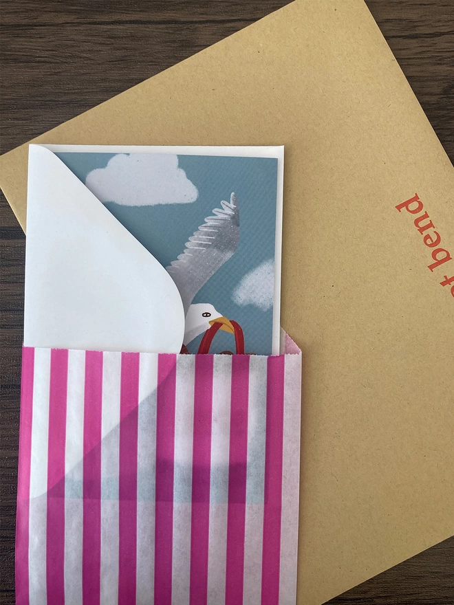 Seagull card packed with a white envelope inside a paper bag
